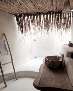 a bathroom with a wooden sink and white walls