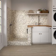 a washer and dryer in a room with tile flooring on the walls