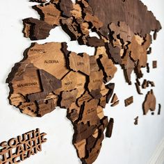 a wooden map of the world on a wall