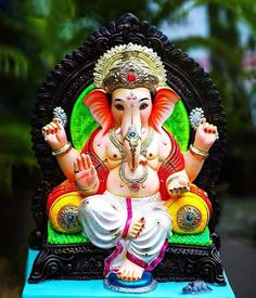 an elephant statue sitting on top of a blue table