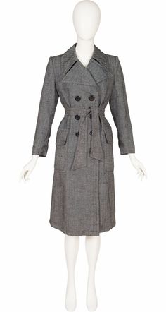 This 1970s Ted Lapidus double-breasted grey herringbone trench coat doesn't list its fabric content but it's likely a wool/cotton blend. It's unlined, with large pointed lapels, two 9" deep flap pockets in the front, and a 20" vent in the back. It comes with the matching tie belt. It's in very good condition; there are a few light marks, but they're hard to spot in the busy pattern. It is clean and ready to wear. Measurements: Bust - 40" Waist - 36.5" Hips - 39" Shoulders - 15.5" Sleeves - 23.5" Length - 42" IMPORTANT NOTE FOR CANADIAN SHOPPERS: There is a 15% shipping fee that is automatically applied to Canadian orders, as legally we need to charge and remit sales tax domestically. We will promptly refund any overcharge, and apologize for any inconvenience. Ted Lapidus, Grey Herringbone, Double Breasted Trench Coat, Herringbone, Double Breasted, 1970s, Trench Coat, Cotton Blend, Jackets & Coats