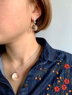 a close up of a person wearing some kind of earrings