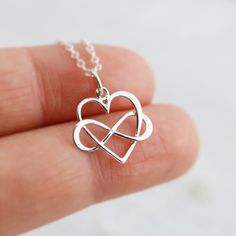 Sterling Silver Infinity Heart Necklace. An adorable heart representing one's infinite love. This handmade piece is the perfect gift for someone you love, or someone wanting to express their long-lasting love for a significant other. A great gift for a bride to be! » Sterling Silver Infinity Heart (18mm including jump ring x 16mm) » Sterling Silver Cable Chain (select from drop-down on upper right) » Your jewelry purchase will come beautifully packaged for gift giving. Personalize It: ✧ Add a Bi Sterling Silver Infinity Heart Necklace For Anniversary, Silver Infinity Heart Necklace For Anniversary, Infinity Necklaces For Valentine's Day, Infinity Necklace For Mother's Day, Silver Adjustable Heart Necklace For Wedding, Adjustable Silver Heart Necklace For Wedding, Infinity Heart Charm Necklace For Valentine's Day, Heart Charm Infinity Necklace For Valentine's Day, Infinity Heart Necklace In Sterling Silver For Gift