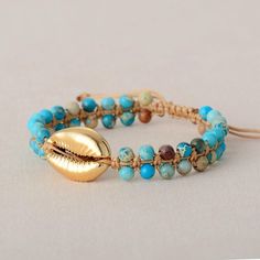 a bracelet with gold leaf charm and turquoise beads