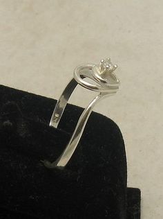 Sterling silver ring with 2.5mm round CZ - R000831. Stamped 925. Approximate weight 1.6 grams. Top width 1.0 cm (0.40 inches), band width 1.5mm (0.006 inches). All our jewels are made from solid sterling silver 925/1000 and are carefully crafted by hand in our family workshop. We dispatch your orders in 5 working days, worldwide and the postage is $5. We ship registered priority mail. Please allow 5-7 working days for delivery in Europe and 10-15 working days outside Europe. For any questions - Classic Silver Birthstone Ring With Tension Setting, Classic Silver Birthstone Ring With Single Diamond, Silver Classic Birthstone Ring With Single Diamond, Silver Diamond Ring With Round Band, Adjustable Sterling Silver Ring With Single Diamond, Classic Sterling Silver Birthstone Ring With Tension Setting, Silver Birthstone Ring With Single Diamond, Elegant Silver Birthstone Ring With Single Diamond, Silver Stackable Rings With Tension Setting