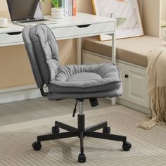 an office chair sitting in front of a desk with a laptop computer on top of it