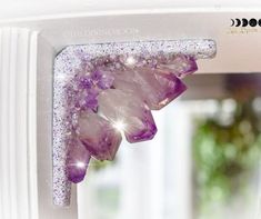 the window is decorated with purple crystals