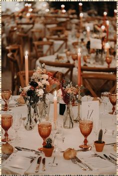 the table is set with candles and flowers