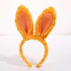 an orange bunny ears headband on a white background