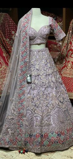 Mauve Purple decorated with cut dana ,french Knot, pearl, zari, stone & sequins embroidered details with multicolor patches on border that radiates charm on lehenga.Complemented with Similarly embroidered blouse and net dupatta. An eloquent bridal lehenga set to amplify your bridal look and celebration with royal elegance. Fabric: Raw Silk Size: 38 Ready to Ship! Lavender Zari Work Sets For Wedding, Lavender Zari Work Wedding Sets, Lavender Wedding Sets With Zari Work, Lavender Wedding Set With Zari Work, Lavender Lehenga With Zari Work For Wedding, Lavender Sharara With Intricate Embroidery For Wedding, Lavender Embroidered Sharara For Wedding, Traditional Drape Lavender Choli For Wedding, Lavender Wedding Choli With Resham Embroidery