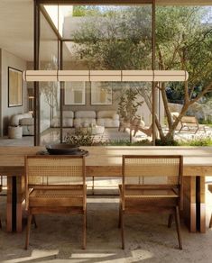 a dining room table with chairs and a bowl on the table in front of it