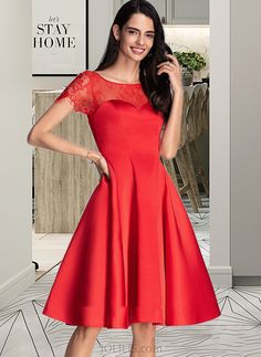 a woman in a red dress posing for the camera with her hands on her hips