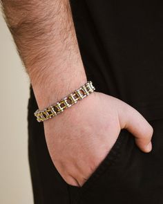 Upgrade your wrist game with our exclusive Bolt Chain Watch Band Bracelet. This sophisticated men's bracelet features a watch band chain that adds a touch of luxury and style to your outfit. Elevate your look with the perfect balance of elegance and functionality. Materials: 14K gold plated stainless steel, rhodium plated stainless steel, ion plated stainless steel Features: Measures 7" length, 0.45" width, Lead & Nickel free, foldover single channel clasp Formal Gold Stainless Steel Bracelet With Box Chain, Formal Gold Bracelet With Box Chain In Stainless Steel, Formal Gold Box Chain Bracelet In Stainless Steel, Stainless Steel Gold Jubilee Chain Link Bracelet, Gold Stainless Steel Jubilee Chain Link Bracelet, Formal Stainless Steel Chain Link Bracelets, Formal Stainless Steel Box Chain Bracelet, Alloy Chain Bangle Bracelet, Metal Box Chain Link Bracelet