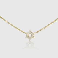 This is a pre-order item and will ship within 7-10 business days. The hint of sparkle, the diamonds and gold lay softly on your chest. This dainty Star of David necklace is ideal for anyone looking to add a pop of sparkle and a pendant full of love, hope, and faith. 14k goldSet with 6 full cut diamonds weighing .06ct total weight 16" chain with 2" extender Choose from white, rose, or yellow gold Star Pendant Size: 1/4" Gold Star-shaped Diamond Necklace Gift, 14k Gold Star Necklace With Single Cut Diamonds, Star Of David Necklace With Single Cut Diamonds, 14k Gold Star Diamond Necklace Gift, Dainty Star-shaped Diamond Necklace For Gift, Gift Diamond Necklace With Star Of David Accents, Star-shaped Necklace With Single Cut Diamonds For Gift, Gold Diamond Necklace With Star Of David For Gift, Star Necklace With Single Cut Diamonds For Gift