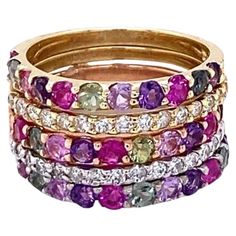 3.06 Carat Multi Color Sapphire and Diamond Stackable Gold Bands Beautifully curated Stackable Bands with Multi Color Sapphires and Diamonds! These bands are so versatile and a best seller for us! 3.06 Carats Diamond Sapphire 14K Gold Stackable Bands Item Specs.: 33 Multi-Colored Sapphires: 2.50 cts. 30 Round Cut Diamonds: 0.56 cts. (Clarity: SI2, Color: F) 14K Tri-Color Bands: 7.4 grams They are stackable and versatile; can be worn together or separate! Band size is a 6 and can be re-sized at n Sapphire And Diamond Band, Red Sapphire, Sapphire Band, Stackable Bands, Jewels Rings, Deco Jewelry, Diamond Rings Bands, Sapphire Stone, Art Deco Jewelry