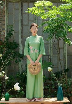 Beautiful shamock green color ao dai set accent lightly with fine embroidery of cherry blossom flowers elegant and beautiful . We pair with white pant. Traditional Vietnamese Clothing, Vietnamese Traditional Clothing, Mint Pants, Vietnamese Clothing, Green Cherries, Vietnamese Traditional Dress, Pants Style, Fashion Baby, Modern Dress