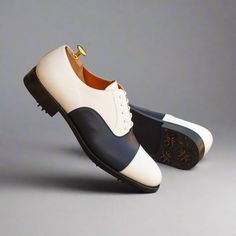 Characterized by its closed lacing style, the oxford is an elegant, classic, timeless style suitable for any occasion. The oxford is a staple shoe in any man’s wardrobe and can be dressed up or down. The Details: Materials: navy box calf + white box calf Lining: orange calf leather Sole: GOLF Last: Zurigo - Rounded toe for fraditional English Look The Fine Print: Shoe production timeline/shipping can vary from 15-30 days from the date of order. All shoes are handmade, small tinny changes or impe White Brogue Oxfords For Semi-formal Occasions, White Brogue-detailed Oxfords For Semi-formal Occasions, White Oxfords With Brogue Detailing For Semi-formal Occasions, Semi-formal White Oxfords With Brogue Detailing, White Wingtip Oxfords For Business, White Oxford Dress Shoes For Derby, White Oxford Dress Shoes For Semi-formal Occasions, White Brogue Oxfords For Formal Occasions, White Oxford Dress Shoes With Rubber Sole