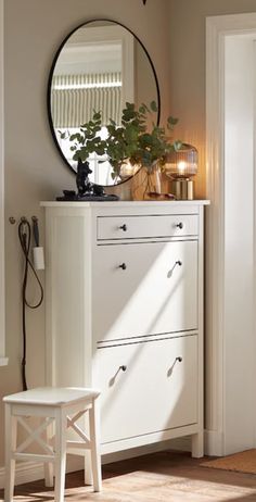 a white dresser and mirror in a room