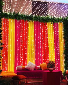 an outdoor stage decorated with bright lights and decorations for a wedding or special event in the evening