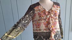 "#vintagebohochic This boho summer colorful blouse is in lightweight chiffon and lace. Classic paisley prints Ruffle front  3/4 sleeves Elastic waist Best fits : S and smaller M  Perfectly paired with denim outfits. Or with light color pants. In Measurements(taken flat): Bust: 17\" Waist: 14\" - 17\" elastic Total Length: 26\" Made in India Excellent vintage condition. To see more items, visit : www.etsy.com/shop/RetroTheory" Bohemian Patchwork Blouse For Spring, Bohemian Spring Blouse With Patchwork, Bohemian Spring Patchwork Blouse, Spring Bohemian Patchwork Blouse, Bohemian Patterned Festival Blouse, Bohemian Blouse With Boho Print, Bohemian Blouse With Lace Trim, Bohemian Patterned Blouse With Boho Print, Bohemian Multicolor Blouse With Vintage Print