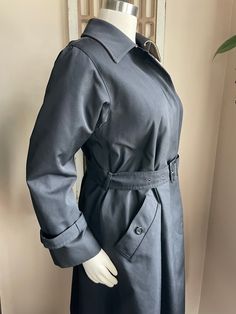 Here we have a Stunning Vintage Hettemarks...det märks trench coat. Made in Sweden. There is a darling belt around the waist and each sleeve wrist. Two pockets with button detail. Four buttons down the front.  Tag Says: Lourden Taylor TORONTO Hettemarks det marks. 65% polyester 35 % Cotton MADE IN SWEDEN Measurements: 20 inches underarm to underarm, 22-inch long arm, 44.5 inches long back of neck to the bottom. Enjoy Free Shipping on All of my items to the Continental USA. (unless otherwise note Fitted Solid Double-breasted Outerwear, Long Single-breasted Fall Raincoat, Fall Long Single Breasted Raincoat, Fall Long Single-breasted Raincoat, Winter Workwear Raincoat, Single-breasted, Winter Workwear Raincoat Single Breasted, Winter Single-breasted Raincoat For Work, Long Sleeve Gabardine Pea Coat With Pockets, Gabardine Pea Coat With Pockets