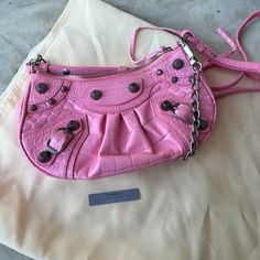 Balenciaga Pink Embossed Leather Shoulder Bag Adjustable Shoulder Strap Zipped Closure With Knotted Leather Puller Aged-Silver Hardware Internal Card Slots Certificate Of Authenticity Included 8.5” X 4.5” (In) Brand New/No Tags 695314 - 5812 - R - 000959 Bags Balenciaga, Silver Hardware, Embossed Leather, Leather Shoulder Bag, Card Slots, Balenciaga, Slots, Shoulder Strap, Bag Lady