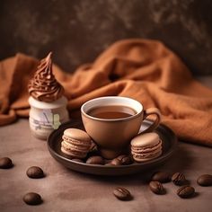 a cup of coffee and some cookies on a plate