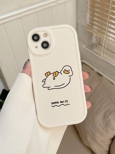 a person holding up a phone case with an image of a bird on it