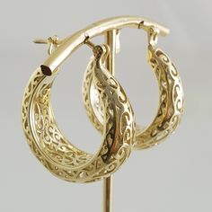 Step into the world of elegance and style with our stunning Gold Plated Filigree Hoop Earrings. Designed to make a statement, these earrings add a touch of glamour to any ensemble. Get ready to turn heads and feel fabulous!Inner diameter: 18mm - 11/16 in.Outer Diameter: 25mm - 1 in.Width at the bottom: 9mm - 3/8 in. Elegant Hoop Clip-on Earrings For Formal Occasions, Elegant Hoop Clip-on Earrings For Formal Events, Elegant Formal Clip-on Hoop Earrings, Elegant Hoop Clip-on Earrings For Anniversary, Elegant Metal Hoop Earrings With Filigree, Elegant Hoop Clip-on Earrings, Elegant Small Hoop Clip-on Earrings, Small Hoop Earrings For Formal Events, Elegant Metal Huggie Earrings For Anniversary