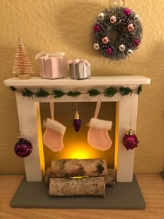 a fireplace decorated for christmas with stockings and ornaments