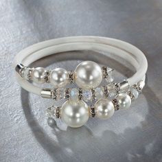 a close up of a ring with pearls on it