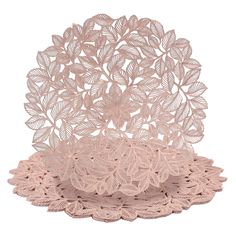 three pink doily plates with leaves on the top and one is made out of lace