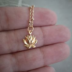 Beautiful 24 Karat gold over sterling silver blooming lotus charm. In Buddhism, a lotus flower signifies the soul rising up from the mud of ego and materialism, through the waters of practice and experience, and up into the sunshine of enlightenment. Measurement includes the ring: (mm) 16 x 10 x 2 The 5mm ring has a 4mm inside measurement so you will need a chain with a narrow end. This is a gem quality gold plate with 40 micro inches of 98.5% pure gold plated over sterling silver that will not Peace Necklace, Blooming Lotus, Lotus Necklace, Light Jewelry, Gold Lotus, 24 Karat Gold, Pure Gold, Lotus Flower, Buddhism