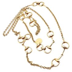 About This Piece: This rare, authentic Gucci Horsebit Chain Necklace is crafted in 18k yellow gold.  Measuring 34.5 inches long, it features the iconic horsebit design, epitomizing Gucci's luxurious style and craftsmanship.  Elegant and versatile, this statement piece is a valuable addition to any fine jewelry collection. Can be worn layered or a single long strand. Just gorgeous!  Includes Gucci booklet. Metal: 18k yellow gold Length: Chain 34.5" Weight: 50 grams Width: 12.5mm Hallmarks: Gucci Gucci Metal Jewelry With Complimentary Chain, Luxury Yellow Single Strand Jewelry, Chanel Ring, Watch Cufflinks, Vintage Gold Earrings, Hermes Jewelry, Gucci Horsebit, Fine Jewelry Collection, Coin Pendant