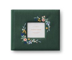 a photo album with flowers on the cover