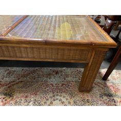 a wicker coffee table with glass top