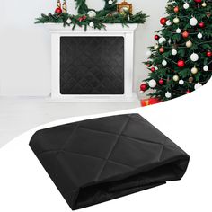 a living room with a christmas tree, fireplace and black leather ottoman cover on the floor