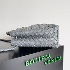 a botega veneta bag sitting on top of a box