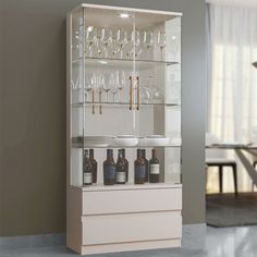 a cabinet with wine glasses and bottles in it