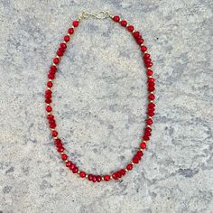 A timeless accessory, this red coral necklace features faceted and round coral beads contrasted by gold plated accent beads, connected with a hook closure. An elegant and sophisticated piece that will luxuriously adorn any look. Red Coral gold plated brass length: 20" Handmade in Lincoln, Nebraska Luxury Red Coral Necklace With Large Beads, Elegant Red Faceted Necklace, Elegant Red Beaded Necklace With Lobster Clasp, Gold Beaded Necklaces With Red Coral, Red Coral Necklace With Gold Beads For Gift, Gold Single Strand Red Coral Jewelry, Gold Necklace With Polished Red Coral Beads, Elegant Red Coral Beaded Necklace With Faceted Beads, Elegant Red Necklace With Gold Beads