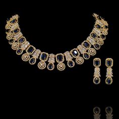 This wear-with-all piece is just perfect for those who love their statement accessories with mixed media flair! Timeless and modern, this hand crafted set dazzle with an elegant frame traced with CZ and sapphire stones. The set includes a necklace and a pair of matching earrings. Approximate earrings length is 1.5". Gold-plated on high-quality brass as base metal. In-stock & ready-to-ship. *Please Note: We use faux stones and beads in all of our jewelry. Opulent Diamond Jewelry For Evening, Elegant Sapphire Necklace With Hand-set Details, Dazzling Hand-set Jewelry Sets For Evening, Dazzling Hand Set Jewelry Sets For Evening, Dazzling Hand Set Jewelry For Evening, Dazzling Evening Jewelry Sets Hand Set, Luxury Crystal Jewelry Sets For Party, Glamorous Diamond Evening Jewelry Sets, Glamorous Evening Diamond Jewelry Sets