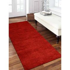 a large red rug in a living room