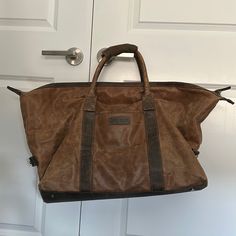 Brown Duffle With Zipper And Long Strap Two Tone L At Bottom Is 20 Inches To Top 27 Inches D 23 Inches H 16 Inches Weekend Duffle Bag, Murphy Brown, Johnston Murphy, Duffel Bags, Duffel Bag, Duffle Bag, Two Tone, Man Shop, Zipper