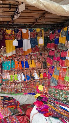 an open market with colorful fabrics and other items