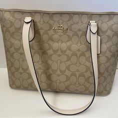 It’s Brand New With Tags Never Been Used Luxury Cream Bag With Zipper Closure, Coach Cream Shoulder Bag With Zipper Closure, Cream Coach Shoulder Bag With Zipper Closure, Coach Beige Shoulder Bag With Large Capacity, Coach Beige Shoulder Bag Large Capacity, Coach Beige Large Capacity Shoulder Bag, Large Capacity Coach Beige Bag, Elegant Coach Bags With Large Capacity, Elegant Large Capacity Coach Bags