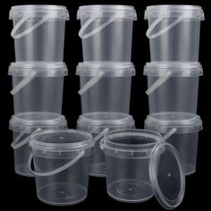 six clear plastic containers with lids on black background