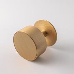 a gold door knob on a white background with no one around it or someone else