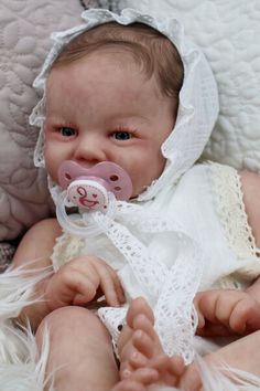 a baby doll with a pacifier in its mouth