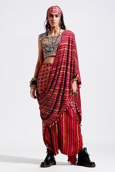 Red pre-draped saree, with multi color printed motifs, highlighted with sequins  spread and cowry shells and tassel embellishments.
Component: 1
Embellished
Fabric: Cotton Silk, Georgette
Color: Red, Multi Color
Cowry shells and tassels on palla hem
Note: The blouse and the bandana worn by the model is for styling purpose only - Aza Fashions Designer Multicolor Tassel Dupatta, Festive Red Pre-draped Saree With Printed Motifs, Bollywood Blouse Piece With Tassels In Traditional Drape, Bollywood Blouse Piece With Traditional Drape And Tassels, Festive Saree Blouse Piece With Tassels, Traditional Pre-draped Saree For Reception With Printed Motifs, Bollywood Style Blouse Piece With Tassels, Bohemian Red Pre-draped Saree For Festive Occasions, Festive Bohemian Pre-draped Silk Saree