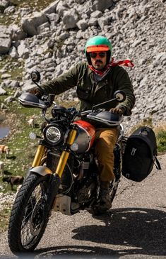 a man riding on the back of a motorcycle down a road